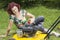 Woman oiling lawn mover