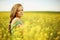 Woman on oilseed field