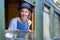 Woman in old-fashioned clothes in window of steam train