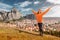 Woman with open arms stands on the viewpoint and enjoys the panorama of Kalambaka town situated near famous monasteries of