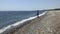 Woman open umbrella at the seashore