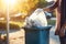 Woman opening bin to throw trash bag at morning. Generate Ai