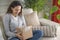 Woman opening personal online shopping parcel. Online shopping at home