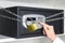 Woman opening steel safe with electronic lock