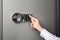 Woman opening steel safe with electronic lock, closeup