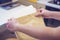 Woman opens brown envelope. brown crumpled paper envelope in hands of female on office background