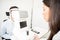 Woman optometrist using tonometer checking patients eyesight