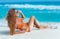 Woman in orange bikini on a tropical beach