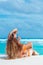 Woman in orange bikini on a tropical beach