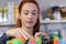 Woman organising colorful bottles spray on shelf