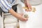 Woman organizing environmental bathroom amenities in drawer and putting bamboo toothbrush into a cup