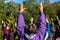 Woman and others practicing yoga outdoors