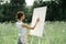 woman outdoors painting a picture creative art landscape