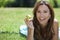Woman Outside Eating An Apple & Smiling