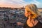 Woman overlooking Jamaa el Fna market square in sunset, Marrakesh, Morocco, north Africa.