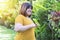 Woman overweight stretching before workout in the garden. Fat girl obesity stretch arm warm up before exercising in