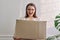 Woman with packaged package, cardboard box. Service for postal delivery