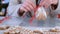 Woman packaging gingerbread cookies with icing for Christmas sitting at table.