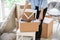 Woman with packed carton box indoors. Moving house concept