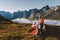 Woman packing camping gear in the morning tent in mountains above clouds active travel vacations outdoor