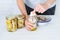 Woman packing canned tuna in glass jars