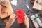 Woman packing Christmas gift at dark table