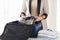 Woman packing formal male clothes into travel bag