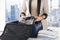Woman packing formal male clothes into travel bag
