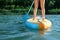 Woman paddle boarding on SUP board in river, closeup