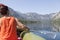 Woman paddle on calm mountain lake