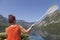 Woman paddle on calm mountain lake