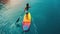 Woman on a paddleboard in a calm lake during sunrise