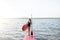 Woman with paddleboard on the pier outdoors