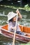 A woman paddles her boat