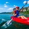 Woman paddles red kayak