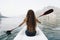 Woman paddling a canoe through a national park