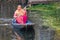 A woman paddling a traditional shikara boat at Dal Lake