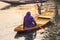 A woman paddling a traditional shikara boat at Dal Lake