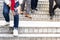 Woman with painful knee struggle walking down flight of stairs