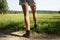 Woman with painful varicose veins on legs resting on a walk through nature