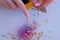 Woman painter artist sharpening blue pencil using sharp knife, hands closeup.