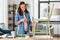 woman painting old chair in grey color at home