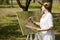 Woman painting outdoors