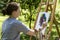 Woman is painting with palette knife