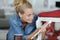 woman painting renewing chair at home