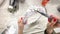 Woman paints a photo frame with white paint.