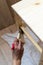 Woman Paiting Varnish onto a Wooden Stool