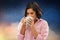 Woman in pajama drinking coffee from mug at night
