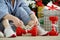 Woman in pajamas and athletic shoes unties the bow on the dumbbells.