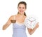 Woman in pajamas with cup of coffee and clock